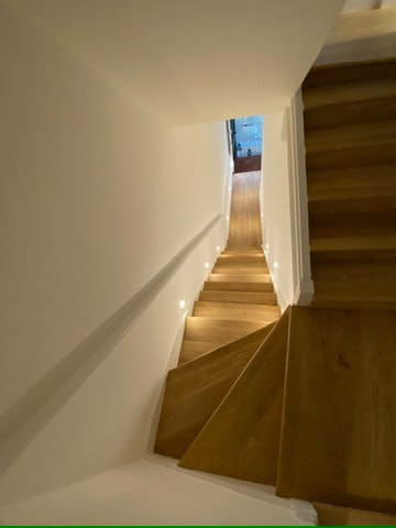 Striking staircase with recessed LED lighting in Wimbledon home