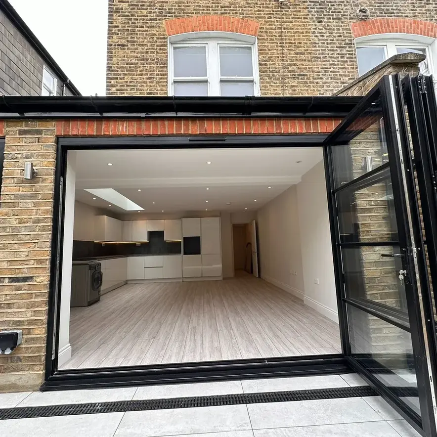 Open plan kitchen extension with bifold doors and skylight Balham