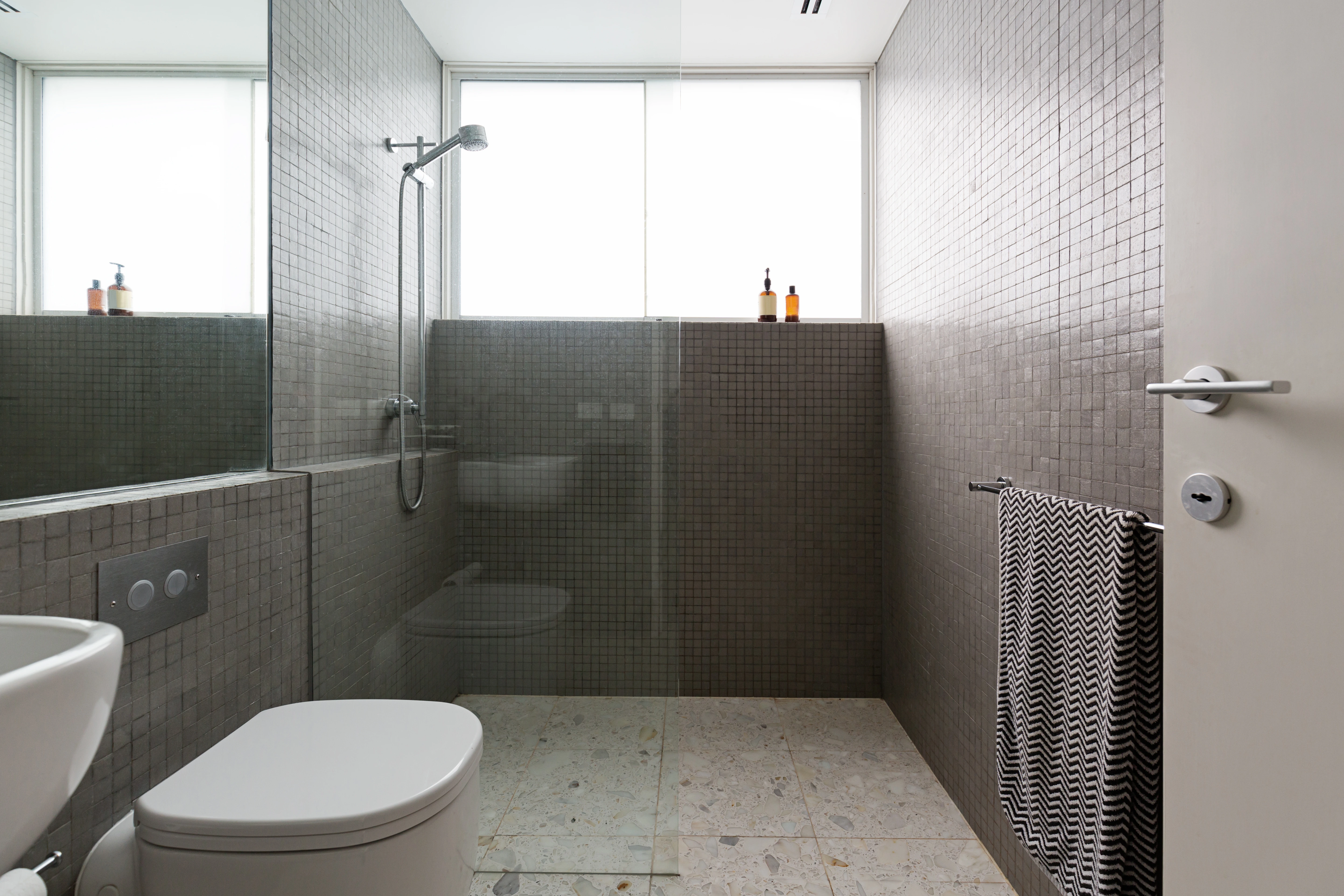 Minimalist wet room bathroom renovation in Kensington with frameless glass and underfloor heating