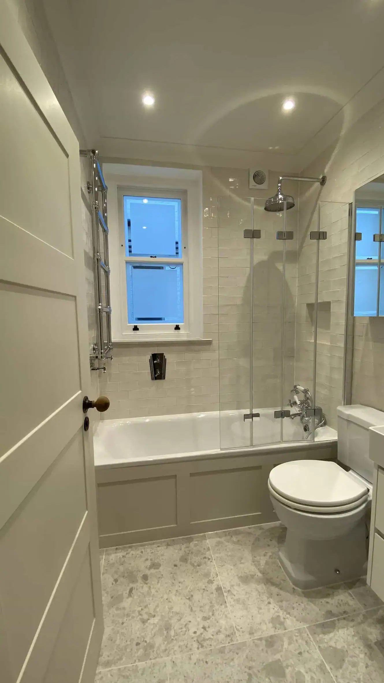 Floating white vanity and close-coupled WC in South Kensington marble bathroom