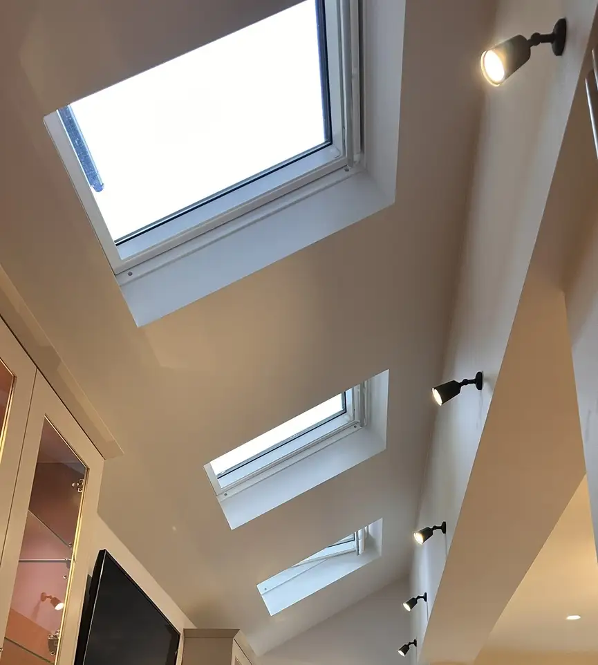 Interior view of multiple rooflights in vaulted ceiling after side extension in Clapham
