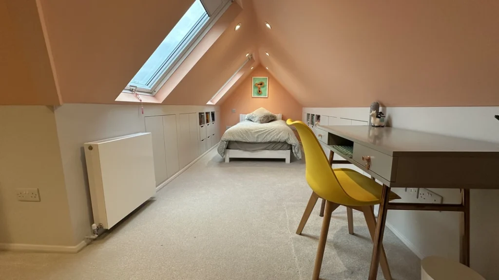 Home by LMDEC LTD Loft conversion Dulwich – bright modern attic bedroom with skylights, built-in desk and custom storage | LMDEC Ltd