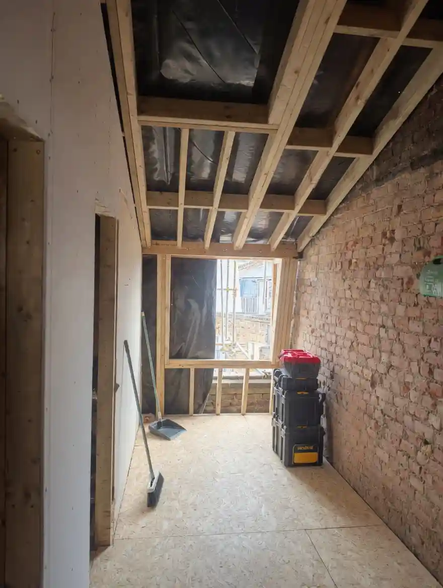 New loft ceiling joists and insulation during construction in Pimlico